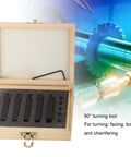 Front view of a wooden tool case with five carbide turning tools set in foam slots