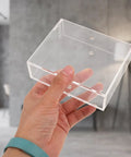 Dual Sided Clear Acrylic Label Roll Dispenser Featuring A Smooth Pull Through Tray Straight Up The Sleek Desktop Organizer held in hand