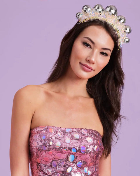 Model wearing Disco Ball Headband For Parties And NYE Fits Adult And Kid Shiny Foil Crown For Birthday Bash Or Holiday Celebration Perfect Disco Bday Decor Hair Accessory.