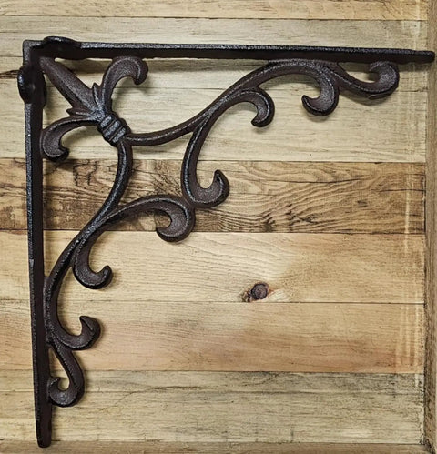Sturdy Cast Iron Shelf Bracket Set 10 By 10 Inches, Ornate Fleur De Lis Design, matte brown finish on wooden background.