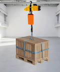 Powerful Heavy Duty Electric Chain Hoist 2200 Lbs Lift With 10 Ft Range And 1300W Motor for lifting a wooden crate.