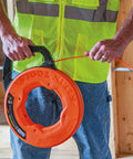 Person using Non Conductive Electrical Fish Tape With Multi Groove Fiberglass Wire Puller Nylon Tip And Pro Grade Housing And Handle
