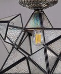 Close-up of Clear Glass Moravian Star Tiffany Style Semi Flush Mount Ceiling Fixture 12 Inch with bulb detail.