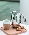 Thermal French Press Coffee Maker 51 Oz Double Wall Stainless Steel Insulated Plunger with cookies on a cork tray.