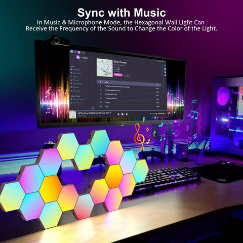 Hexagon Geometric RGB Wall Light Kit With Remote Control Touch Sensitive Modular Panels USB Powered Color Changing LED Mood Lighting For Bedroom 6 Pack Easy Install placed on a desk with colorful lights syncing to monitor display.
