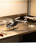 Model helicopter on workbench with tools and Beefy Carbon Fiber Rods 1.64 ft Long 0.08 in Diameter, 10 Pack Round Bar nearby
