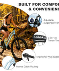 Woman riding Womens 26 Inch Mountain Bike With Shimano 21 Speed Rear Derailleur Twist Grip Shifter Dual Disc Brakes Lockout Suspension Fork Steel Frame Two Point Three Five Inch Tires Eighty Five Percent Pre Assembled Ride Ready Cyan in forest.