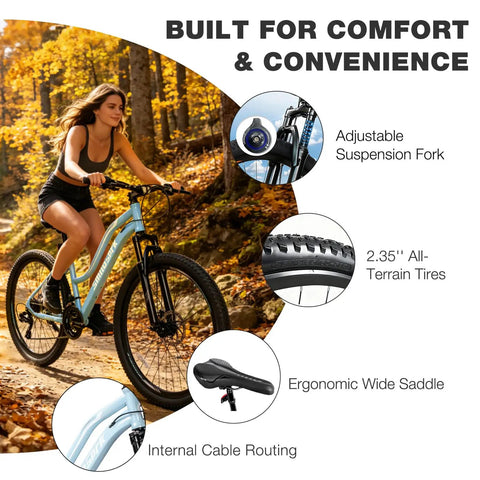 Woman riding Womens 26 Inch Mountain Bike With Shimano 21 Speed Rear Derailleur Twist Grip Shifter Dual Disc Brakes Lockout Suspension Fork Steel Frame Two Point Three Five Inch Tires Eighty Five Percent Pre Assembled Ride Ready Cyan in forest.