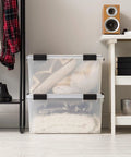 Legit Heavy Duty Stackable Storage Tote Bins 8 Pack 62.8 Quart Clear Black Plastic Gasket Boxes used for blankets in a closet.