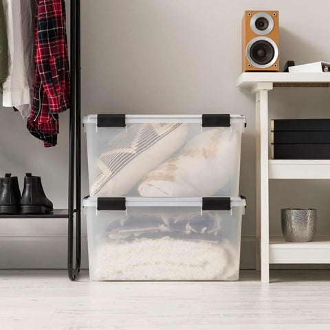 Legit Heavy Duty Stackable Storage Tote Bins 8 Pack 62.8 Quart Clear Black Plastic Gasket Boxes used for blankets in a closet.