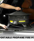 Person placing Smokeless 24 Inch Portable Propane Fire Pit With Grill Grate And Lid 60 000 BTU Outdoor Firepit into car trunk