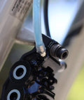 Close-up of bike brake with flexible hose connected from Magura Hydraulic Disc Brake Bleed Kit For Magura Brakes MTB Bike Maintenance Kit.