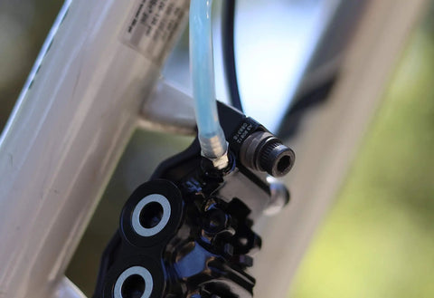 Close-up of bike brake with flexible hose connected from Magura Hydraulic Disc Brake Bleed Kit For Magura Brakes MTB Bike Maintenance Kit.