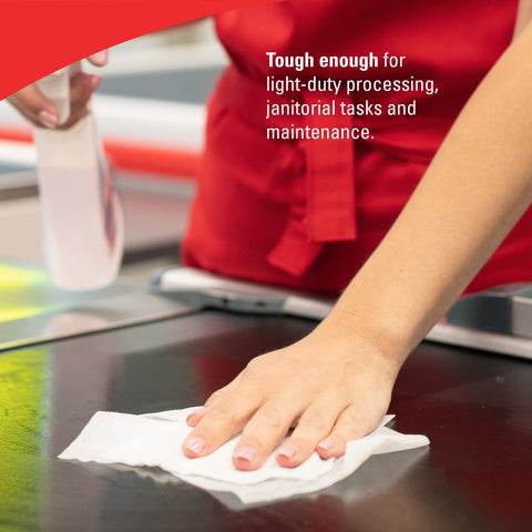 Hand using GeneralClean L30 Cloths Heavy Duty Cleaning Wipes Bulk White Wipers For Light To Medium Duty Cleanup on counter.