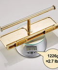 Double Roll Toilet Paper Holder With Shelf In Solid Brass And Polished Gold Finish on scale showing 1226g weight