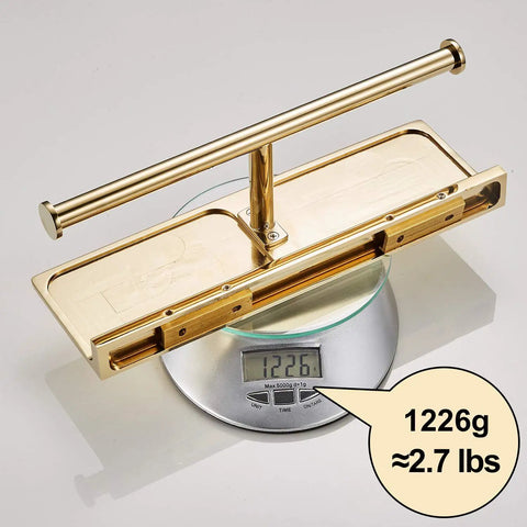 Double Roll Toilet Paper Holder With Shelf In Solid Brass And Polished Gold Finish on scale showing 1226g weight