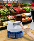 Person using Eight Slot Coin Sorter and Counter with eight bins on a wooden counter in a grocery shop setting.