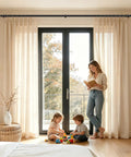Telescoping Curtain Rod Adjustable From 32 To 58 Inches And 20 To 53 Inches Splicing Design Three Quarters Inch Drapery Rod In Black installed above a bright window with beige curtains, mother reading to children in a cozy room.
