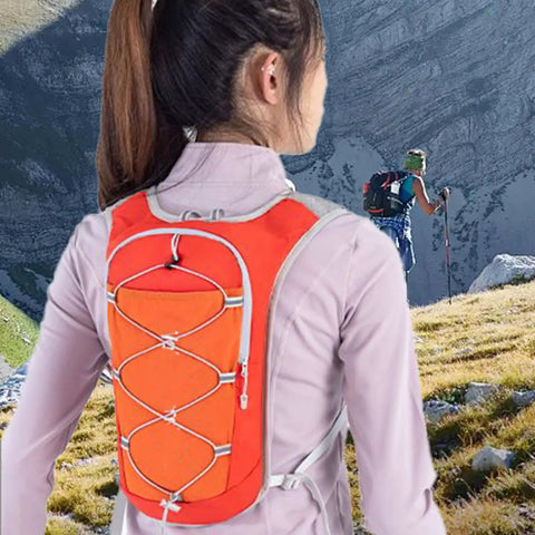 Trail Ready Hydration Vest With Adjustable Chest Straps worn by hiker outdoors, lightweight pack for running, cycling, hiking