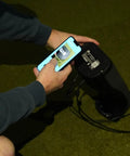 Person using smartphone to set up Indoor Personal Launch Monitor With Pay As You Go Software For Realistic Golf In Your Garage Or Basement.