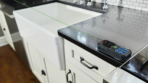 Blaze Green Beam Laser Distance Measure With 165 Foot Range And One Sixteenth Inch Accuracy on kitchen counter