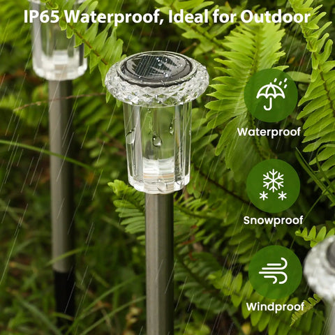 Close-up of Solar Outdoor Lights 12 Pack Waterproof Pathway Lights With Auto On Off Plug And Play Yard Patio Landscape Walkway Lighting 12 Hour Bright Starburst LEDs in rain