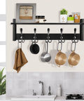 Coat Rack With Shelf And Tri Hooks Wall Mounted 24 Inch Wooden Hanging Coat Hanger For Entryway Bathroom Mudroom And Bedroom Black Finish With Stable Iron Frame For Everyday Use in a kitchen setting with pots and a towel hanging.
