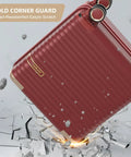 Red 18-inch carry-on luggage with gold corner guard, removable spinner wheels, and TSA lock shown mid-motion over cracked surface.