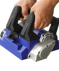 Hands gripping the handles of a Heavy Workhorse 1300W Handheld Wall Planer, Smooth Operator Electric Wall Scraper.