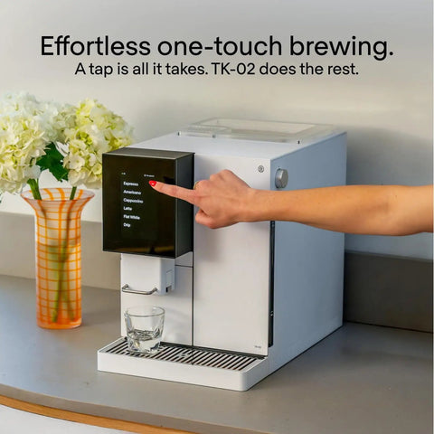 Person using No Fuss Fully Automatic Espresso Machine With App Control And Auto Wake And Sleep For All Milk Types Roaster Approved Espresso Settings And Cappuccino Maker For Home Use, white color on kitchen counter.