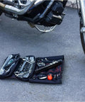 Ride Ready 48 Piece Motorcycle Tool Kit In A Compact Roll Up For Harley Davidson Indian And Other V Twin Bikes on ground near bike