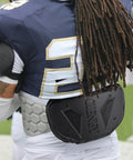 Back view of football player wearing High Impact Football Back Plate For Shoulder Pads Universal Youth And Adult Protection.