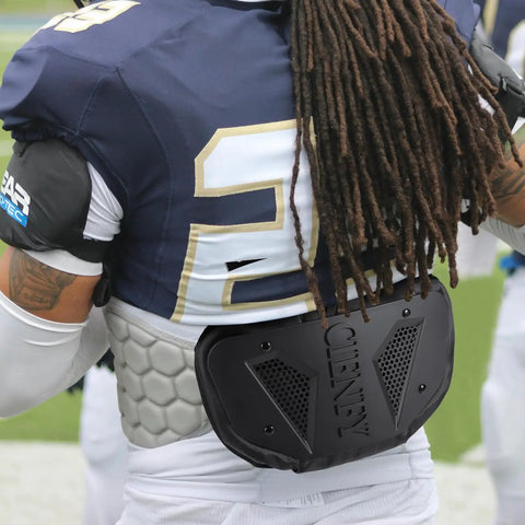 Back view of football player wearing High Impact Football Back Plate For Shoulder Pads Universal Youth And Adult Protection.