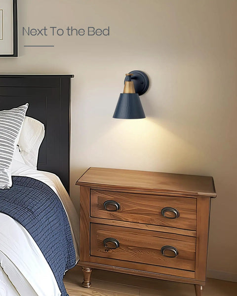 Modern Wall Sconce Set of 2 With Hammered Metal Shade in Dark Blue, E26 base, mounted beside a wooden bed in bedroom scene