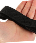 Hand holding black strap from 8Pcs Garden Aerator Shoes Straps Durable Aerating Sandals For Lawn For Men And Women Boost Soil Nutrient Uptake