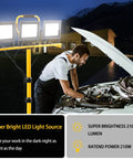 Beastly Bright 22000 Lumen LED Work Light With Adjustable Foldable Tripod Stand lighting up a car engine repair at night outdoors