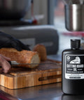 Cutting Board Oil And Wood Butcher Block Oil 128 Oz One Gallon Jug Brewed In USA With FDA Food Contact Safe Ingredients A True Kitchen Workhorse For Cutting Boards Spoons And Countertops Black Finish next to sliced bread on wooden board