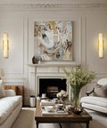 Brushed Brass And Natural Alabaster Wall Sconces Set Of Two casting soft light in a stylish living room with modern decor.