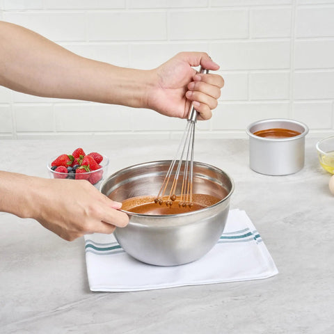 Person using Stainless Steel Ball Whisk With Silicone Tips 10.5 Inch 24 Pack in mixing bowl on kitchen counter