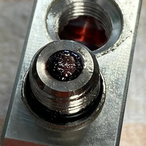 Close-up of Automatic Transmission Fluid Thermal Bypass Valve for GM 6L80 Transmissions 2014-2018, part 125068000, metal surface