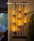 Wall sconce with 24 Pack Flameless Votive Candles Tealights Warm White Ivory Base Christmas Decor illuminating a room.