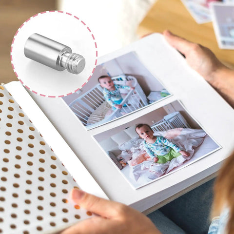 40 Pack Chicago Screws And Scrapbook Extension Posts Crafted From Hella Durable Solid Copper With Rust Proof Binding Hardware For Photo Albums shown mounted in scrapbook with baby photos.