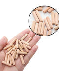 Wooden Dowel Pins 48 Pieces 6mm By 25mm And One Quarter Inch By One Inch Fluted Beveled Ends Hardwood Pegs in hand and close-up view