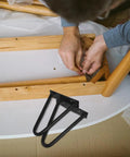 Person installing Black Iron Hairpin Table Leg Set, 2 Pack, Heavy Duty Easy Install Metal Furniture Legs on wooden table