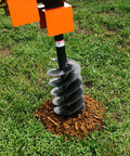 60 HP Three-Point Post Hole Digger With Nine Inch Auger Attachment for Cat 1 Tractors drilling into grass soil
