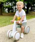 Toddler Balance Bike for 1 Year Old Baby Boys Girls First Birthday Gift No Pedal Closed Wheels with a child riding outdoors.