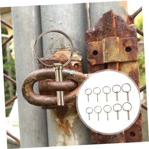 Beefy 10 Pack Heavy Duty Lynch Pin Kit with spring loaded quick disconnect rings securing a rusty gate.