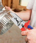 Person using Five Blade Hand Crimper Pro Grade Heavy Duty Rust Resistant Gutter Crimping Tool on HVAC duct.
