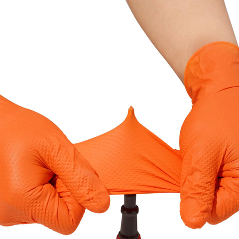 Hands wearing Tough As Nails Industrial Orange Nitrile Work Gloves With Solid Eight Mil Thickness and Raised Diamond Texture stretching the glove.