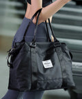 Versatile Travel Gym Bag For Women With Wet Pocket Carry On Duffle Tote Luggage shown on woman's shoulder